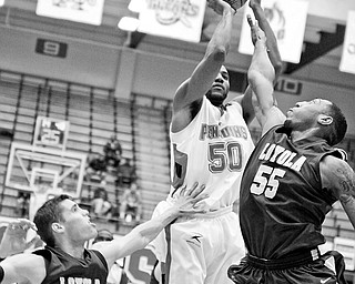 YSU Jack Liles (50) gets blocked by Loyola's Aric Van Weelden (12) and Darrin Williams (55) Saturday January 10, 2009