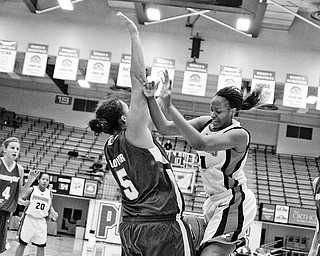 YSU's Tiara Scott (21) loses control of the ball as it slips between herself and Green Bay's Lavesa Glover (5). Only to recover it quickly and score 2 points to make it YSU 42- GB 54 during the 2nd period at Beeghly