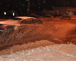 A car makes its way through high water on Mahoning Avenue in Youngstown.