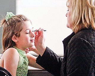 Carlie Oddo (10) of Canfield gets mascara put on by Mari Ellen Warvell of New Castle at Chevy Centre. Carlie participated in The Skating Club of Greater Youngstown's annual skating competition Sunday January 11, 2009