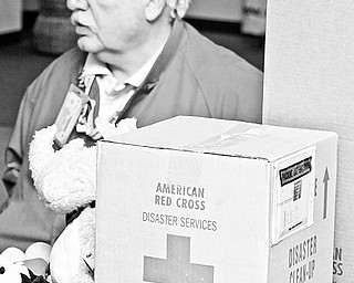 George Braindard of Austintown talks about the American Red Cross Disaster relief. Supplies for emergency relief sit on the table in front of him