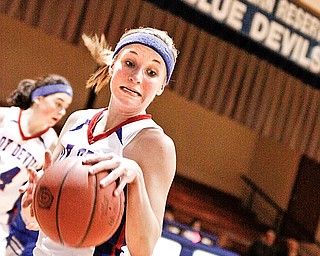 Lady Devil Matti Shahaden (12) catches the rebound from McDonald and tries to stay in bounds with control of the ball