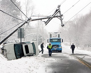 Snow and slippery roads caused a single car wreck on St Rt 62 - just south of 165 closed St Rt 62 for some time as the car snapped a pole and brought down electrical wires - unknown how many people were in the car but an ambulance did leave the scene as I arrived - Perry Twp. Police Dept handled the crash
