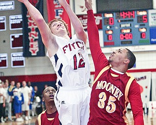 Shane Stevens of Fitch shoots past Chuck Gruber of Mooney during Tuesday action at Fitch.