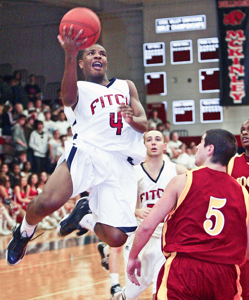 William Mahone of Fitch drives to the hoop past Donald D'Alesio of Mooney during Tuesday action at Fitch.