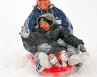 Hayden, 3 1/2, and mom, Amanda Taylor of Hubbard, didn't let a little snow and cold stop their fun as they played on the hills in Wick Recreation area in Mill Creek Park