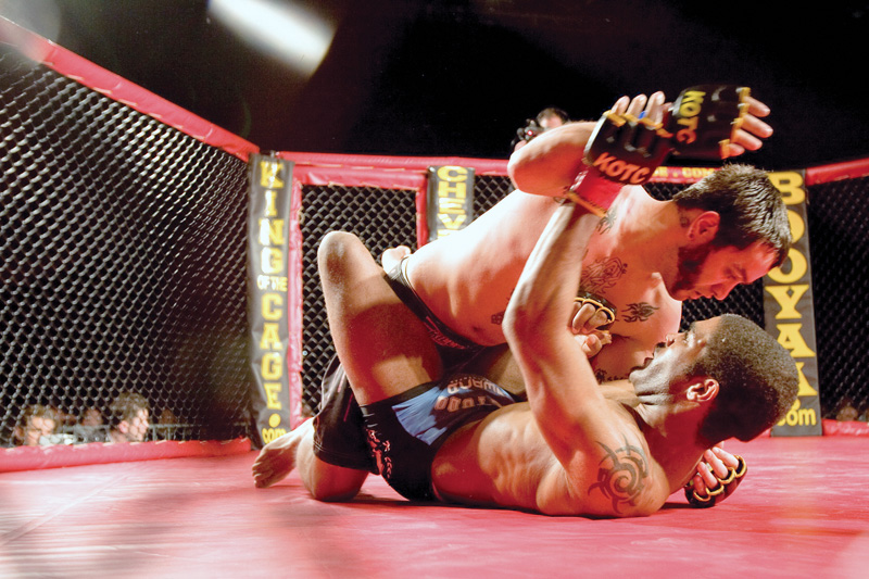 Mike Cardona fights Chris Curtis during one bout at King of the Cage at the Chevy Centre Saturday evening.