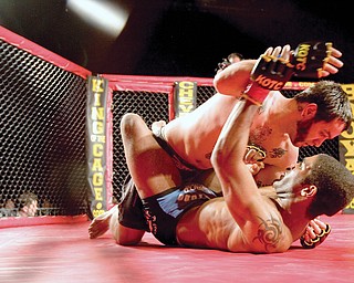 Mike Cardona fights Chris Curtis during one bout at King of the Cage at the Chevy Centre Saturday evening.
