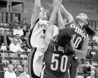 YSU's Kelsey Gurganus (14) takes a shot while being blocked by Cleveland State's Jessica Roque (50) and Takima Keane (10) during the second half of a matchup between the two teams Saturday afternoon at Beeghly Center.