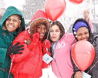 Ms. Lane, Tyler Johnson, Kassandra Roman and Alexis Taylor stand outside Williamson Elementary in Youngstown to release balloons with paper attachments of their hopes and dreams, Tuesday January 20, 2009