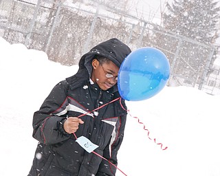 Anthony Dickerson holds a balloon to be released at Williamson Elementary in Youngstown, Tuesday January 20, 2009