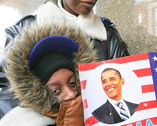 Beatrice Nelson and her son Rashaan Nelson 8, both of Youngstown, make their way to the inauguration