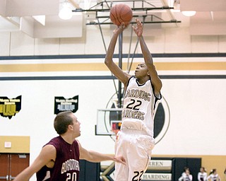 GOING UP: Warren Harding Tre' Browm takes a shot as BOardman's Eric Soller defends during the fourth quarter of Tuesday's game in Warren.