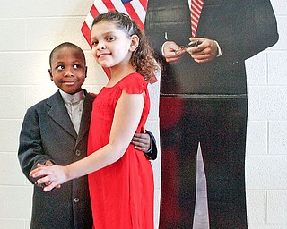 DANCING WITH A STAR: Naelemn Hasley, 6, left, and Alicia MOore, 7, pose in front of a cardboard cutout of President Barack Obama. They were selected to represent the presidenta dn first lady at an inaugural ball Wednesday at Paul C. Bunn Elementary School