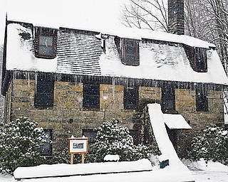 Mill Creek MetroParks’ Pioneer Pavilion, built in 1821, is undergoing a restoration project. Below, work on the exterior stone staircase, a popular spot for wedding photographs, was recently completed.