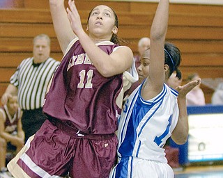 TWO TIMES 11: Liberty's Melissa Dykes (11) shoots for two over the head of Hubbard's Michelle Starkey (11) during Wednesday's matchup.