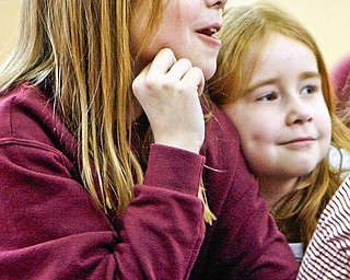 Rapt attention - Sarah Hoffman and Tessa Katcher both second graders listen intently to Margaret Klein as she reads and interacts with students at the after school program - at West Boulevard Elementary