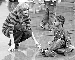 Chad Fullum gets some advice from an aide of Becky Cantanzriti - at the after school program - at West Boulevard Elementary