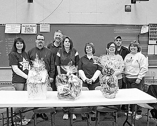 <p>Special to The Vindicator</p>
<p>BANDING TOGETHER: Committee members show off some of the baskets for the upcoming reverse raffle hosted by the Boardman Band and Orchestra Parents. From left are Clara Christmas, Mike Gunter, Gary Paull, Debbie Egner, Renee Simari, Patti Grim, Gary Grim and Cheryl Dutko.</p>