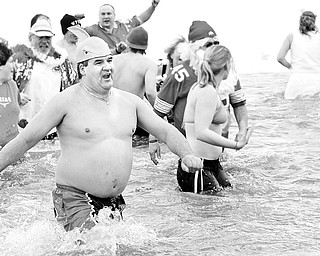 Ryszard Olek of Brookfield wears a shark fin hat as he dove in to Mosquito Lake for Polar Bear Plunge, Saturday January 24, 2009