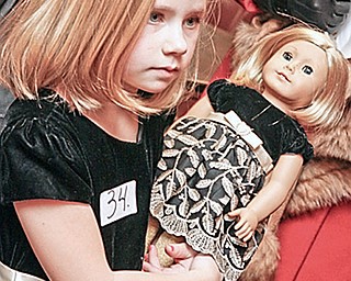 Kelley (or Sydney) (7) Ferguson of Austintown holds her American Girl doll as she prepares to audition for the American Girl Fashion Show tryouts at St. Michael Church in Canfield, Sunday January 25, 2009