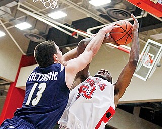 DeAndre Mays of YSU shots over Eric Buggs of Valpariso during Thusday's game.