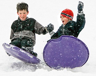 SOME SNOW IS FUN as Brian Yauger 8 and Jeffrey McAuley hold hands as they hit a bump on the park area in front of Poland Presbyterian church