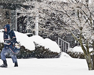 US Postal Service letter carrier John Poprik, who has been delivering mail for 21 years, trudges through Wednesday's snowfall along Leyton on Youngstown's Westside.