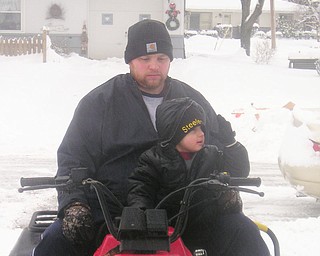John of Boardman and his 3-year-old son Kamron set out to help some neighbors on Harrow Lane dig out from the big snow on Jan. 10.