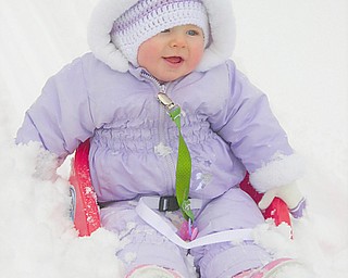 Madeleine Devlin, 10 months, daughter of Karl and Lisa Devlin of Austintown, gets her first taste of snow this year.