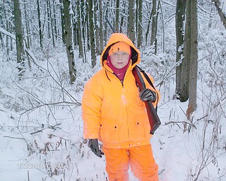 Caleb Johnson, 9, a student at Roosevelt Elementary in Hubbard, treks though the snowy woods with his grandfather, Jim McCullough, on his
second day of youth deer hunting season.
