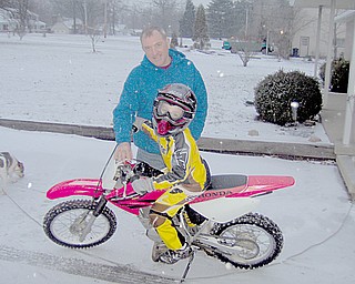 Kevin tests out his dirt bike with Granpa Bill Valentino.