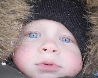 3-year-old Preston English presents some rosy cheeks for his mom Rene to snap on their first snow day of the year.