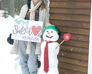 Kathryn Mason, a junior at Canfield High School, delivers a snowman invite to senior Tommy Johnson for the Sweethearts Dance on Feb. 21.