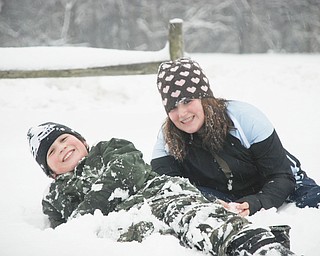Hunter Troggio and sister Charley of New Middletown entertain Grandma Renee Bero during this year's first snow storm.