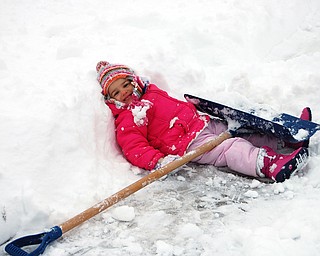 Allison Jones, 3 1/2, takes a break from shoveling with her mom, Sally Jones of Canfield during the Jan. 10 snow storm.