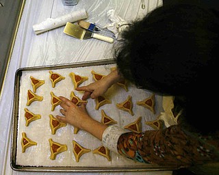 Putting on a crust is Sherri Clayman  as the church makes Hamentaschen cookies for Purim- robertkyosay