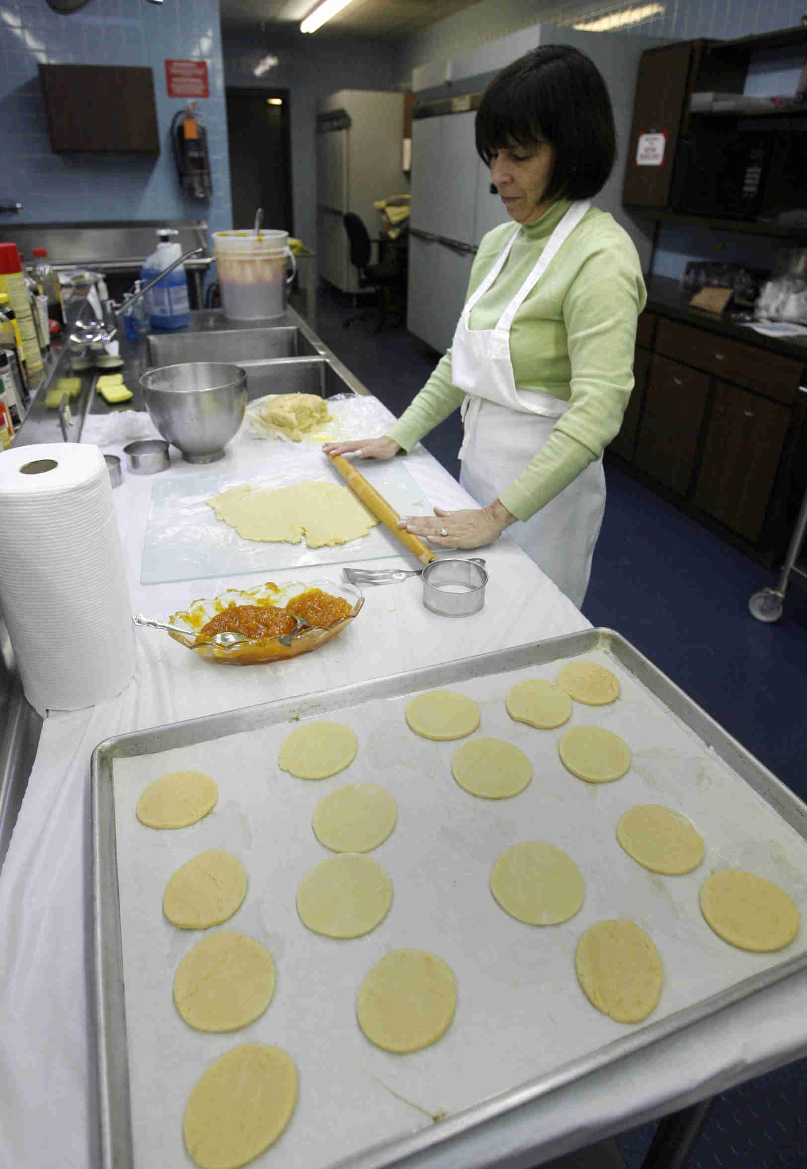 Debbie Grinstien rolls the dough to be cut into  the cookies as the church makes Hamentaschen cookies for Purim- robertkyosay