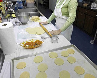 Debbie Grinstien rolls the dough to be cut into  the cookies as the church makes Hamentaschen cookies for Purim- robertkyosay