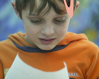 Brendan Thoreson reads one of the stories students wrote about being stranded on an island and then put in a bottle - as Right to Read week activities got underway at Robinhood Elementary in Boardman - 