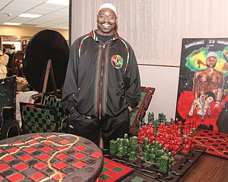 Professor Peacock (49) of Columbus stated that in chess "white moves first -so its subliminally racist." Playing chess has been proven to improve test scores, so he crafts chess board tables and pieces to encourage youth to learn strategies instead of participating in gangs. YSU's African Marketplace for Black History Month in the Chestnut room at Kilcawley Center, Saturday February 7, 2009 ** If you also want to diminish youth violence, You may contact him at testscorerise@yahoo.com