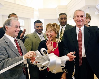  Millicent Counts (center) applauds as Carlton A. Sears and Dr. David Ritchie cut the ribbon. Behind them are Mayor Jay WIlliams (not seen) 2nd Ward Councilman DeMaine Kitchen and former Councilman Rufus Hudson at the ribbon cutting of the new East Side Library.