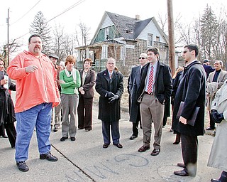 MAN WITH A PLAN: James London, president of the Idora Neighborhood Association, shares his concern about the vacant property issues in his neighborhood with a group of state and city officials and community residents during a bus tour conducted by the Mahoning Valley Organizing Collaborative. Tuesday’s tour of the Youngstown neighborhoods was the precursor for more than 50 people who were attending the public meeting with Lt. Gov. Lee Fisher.