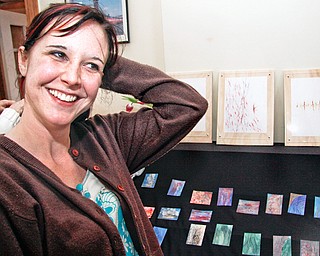 Artist Lisa Zitello of Austintown with her artwork at the Artists of the Rust Belt exhibition in B & O Station, Sunday February 22, 2009