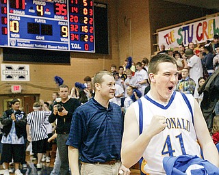 David John of McDonald reacts at end of Tuesday game where Blue Devils beat Springfierld for a20-0 record. Coach Jeff Rasile is at left.