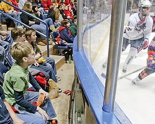 Beaver Local 6 th graders Josh Beck, left, and Jack Dawson take in the action up close and personal duringTuesday morning Phantons/USA National Team hockey game at the Chevy. Hundreds of local school children attended the event.