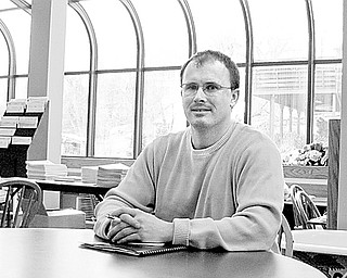 CURRENT LIBRARY: Andy Smith, the librarian of the Leetonia library, is shown in the present library. A new library is expected to be completed by mid-summer.