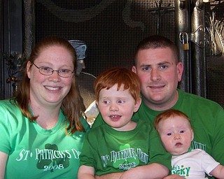 REASON TO CELEBRATE: This picture of the Courson family (Katie, Alex, Allison and Jeremy) was taken last St Patrick’s Day. Jeremy was deployed that day to Afghanistan. He is due back by this St. Patrick’s Day.