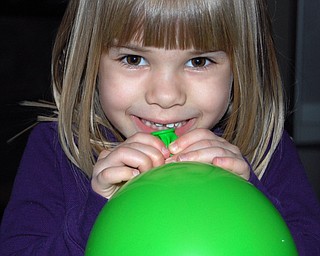 BURSTING WITH PRIDE: Samantha Jones, 4 1/2, of Canfield has success in blowing up her green balloon! Photo was taken by her mom, Sally Jones.