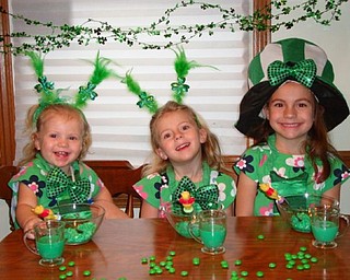 THE GREEN GIRLS: The DiFabio sisters, Julianna, 16 months, Arianna, 3, and Brianna, 5, of Poland are enjoying their St. Patrick's Day cottage cheese and green milk.